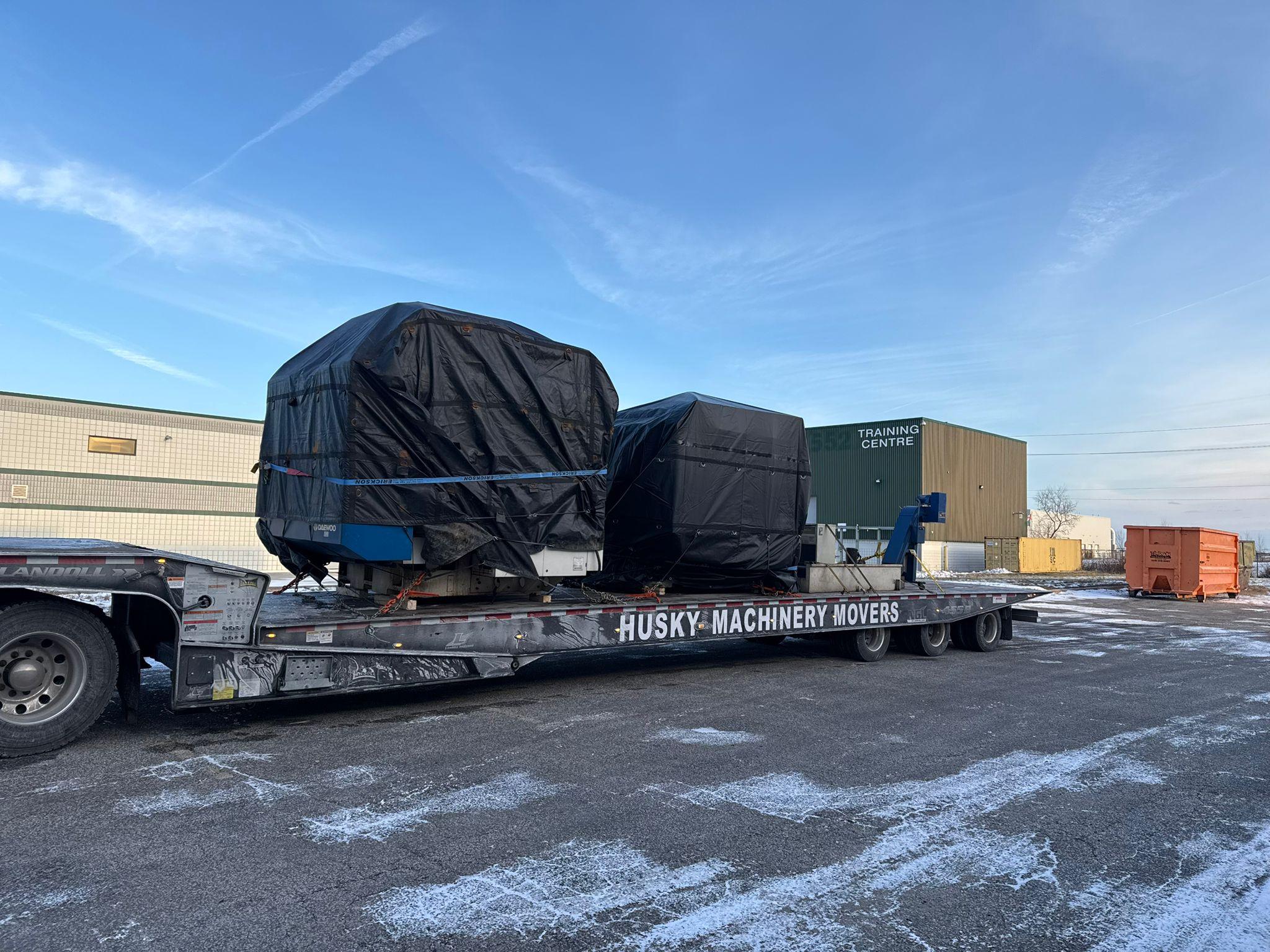 Expert millwrights installing and aligning precision manufacturing equipment with specialized rigging tools