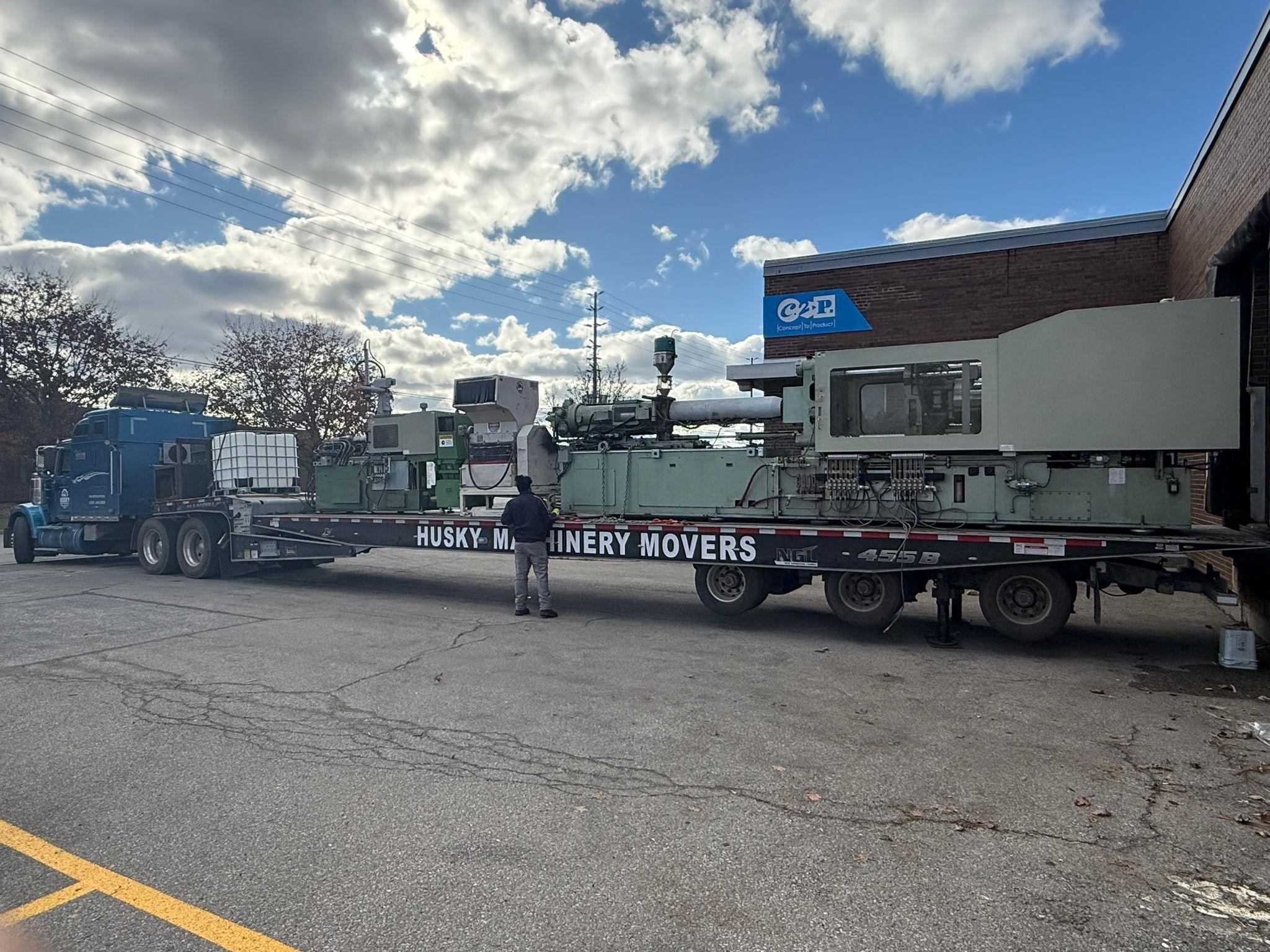 Professional machinery movers relocating heavy industrial CNC equipment in Ontario manufacturing facility - Husky Machinery Movers