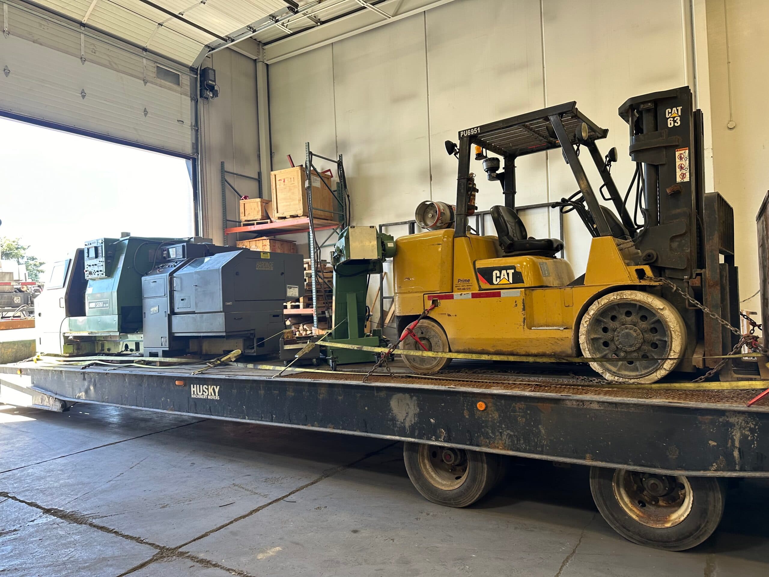 Expert millwrights installing and aligning precision manufacturing equipment with specialized rigging tools